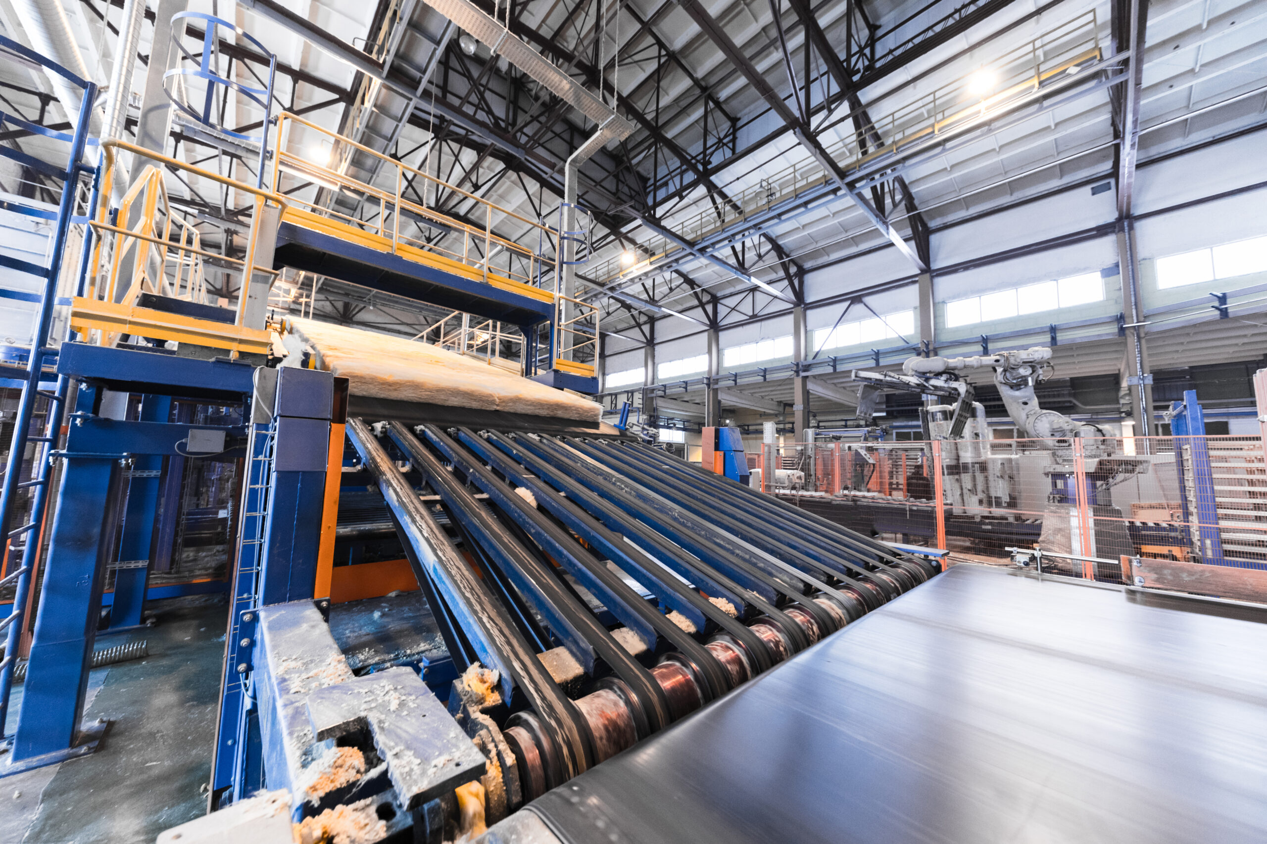 Modern operational plant equipment assembly line producing fiberglass batt heavy industry machinery metalworking workshop concept.